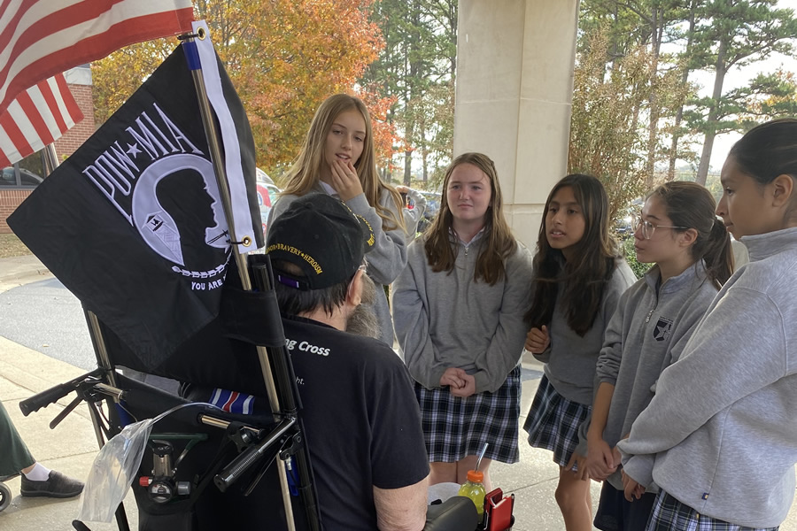 Girls talking with local veterans