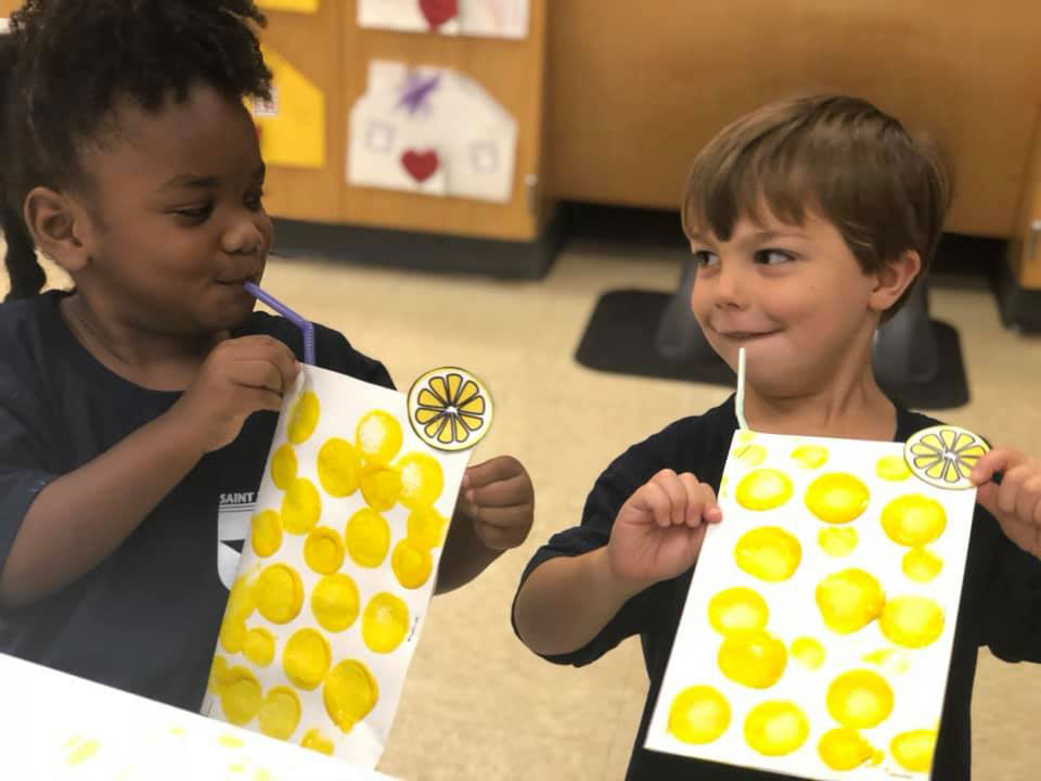 ATwo children with their art projects