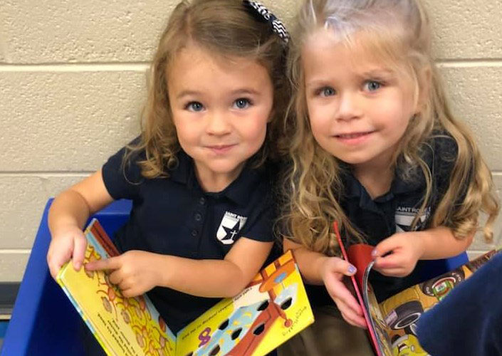 Two girls reading a picture book together